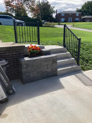 Concrete steps with block retaining wall and railing