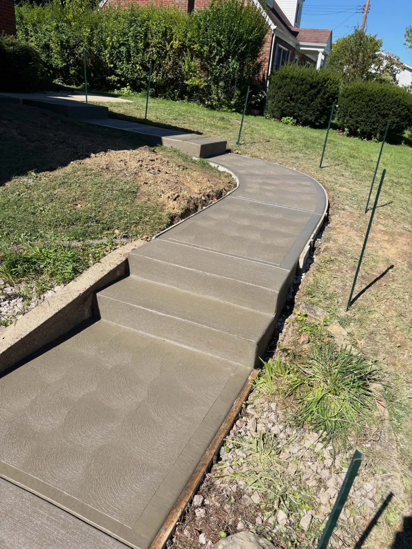 Curved concrete walkway with steps